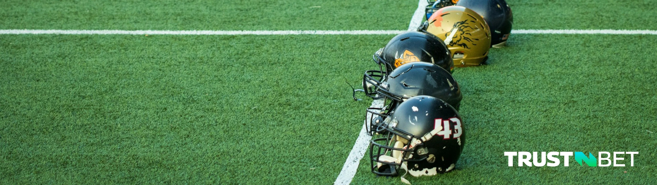 American football helmets on a field.